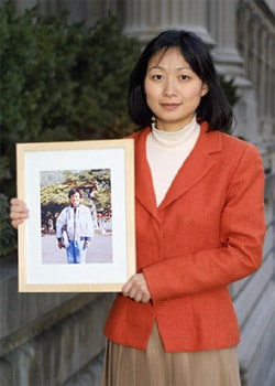 New Yorker Christina Yuan holding a photo of her mother who has suffered extreme torture in a Chinese labor camp for her practice of Falun Gong.