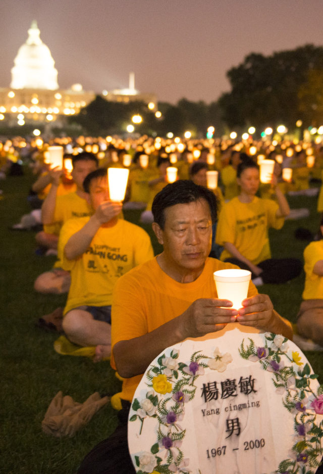 Falun Gong practitioners and supporters hold a candle-light vigil in Washington DC for those killed in China.