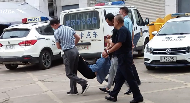 Ms. Zhou Ailin, a former auditor at the Qiaokou District Industrial and Commercial Bureau in Wuhan is arrested and taken to a "brainwashing" center.