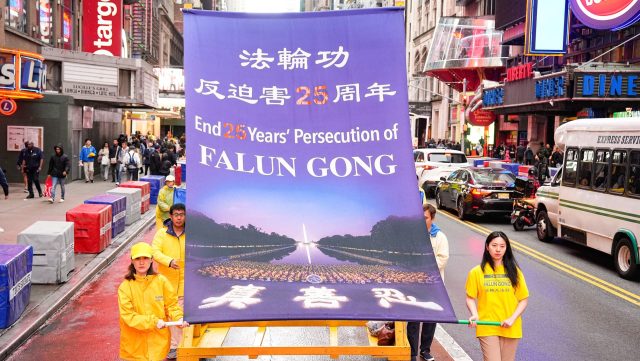 Falun Gong practitioners carry a banner in a May 13, 2024
procession in New York commemorating the anniversary of Falun Gong’s
introduction to the public. (Source: Tuidang Center)