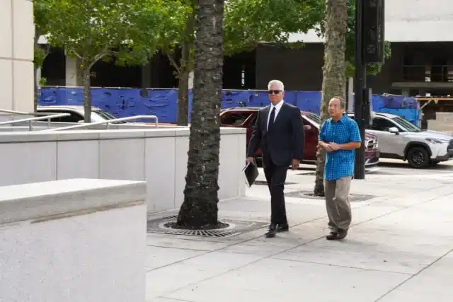 Florida engineer, Ping Li, and his lawyer, Daniel Fernandez, arrive at the U.S. District Court for the Middle District of Florida ahead of a court hearing in Tampa, Fla., on Aug. 23, 2024. (T.J. Muscaro/The Epoch Times)